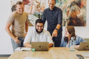 Group of four people working in an office